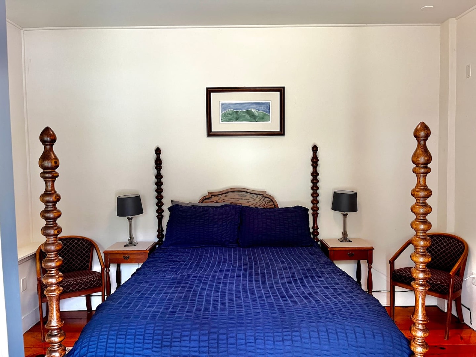 Bluebird’s bedroom with blue bedding and a wooden four-poster bed