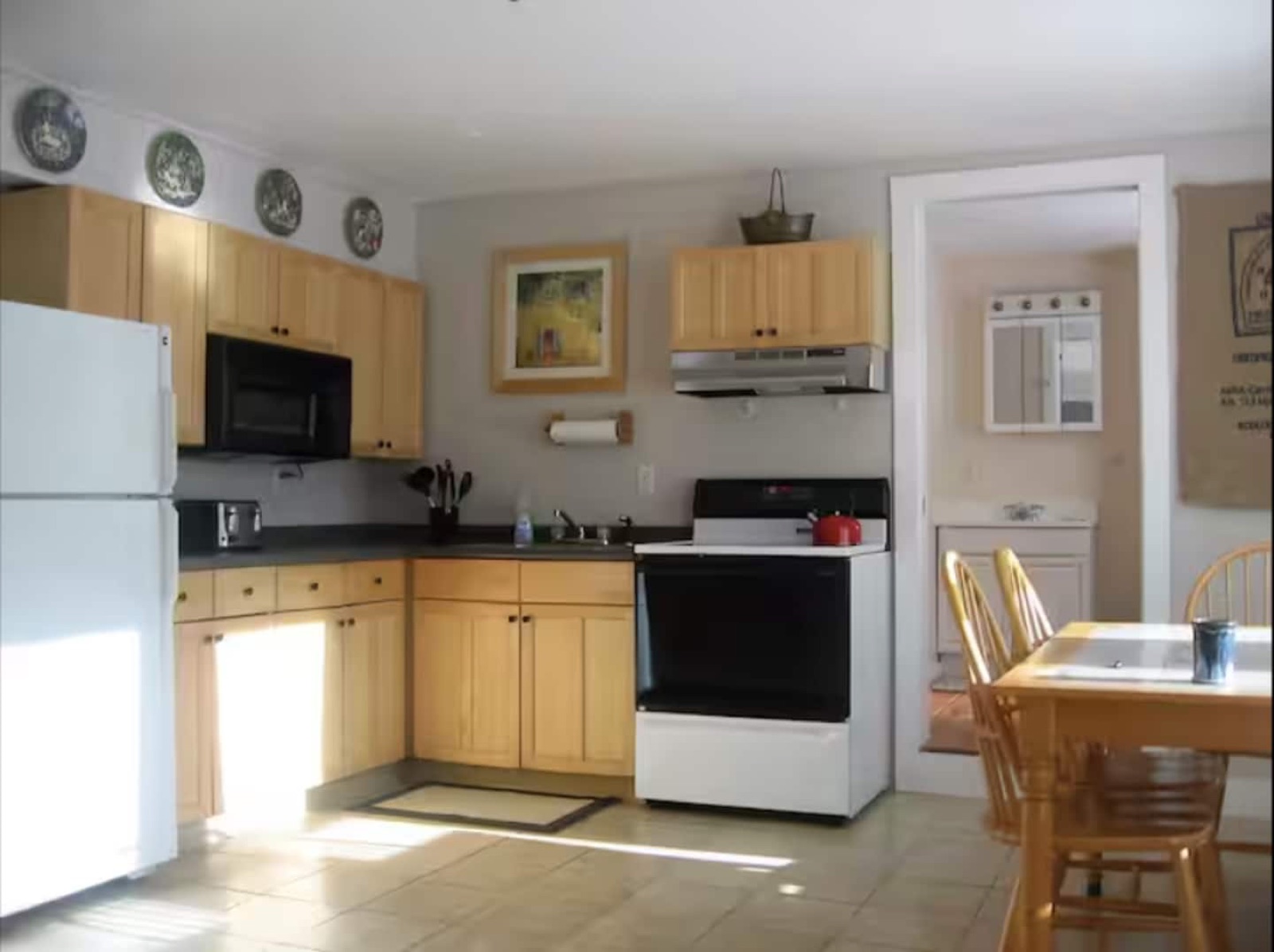 Sandpiper’s sunlit kitchen and dining area with wood cabinets