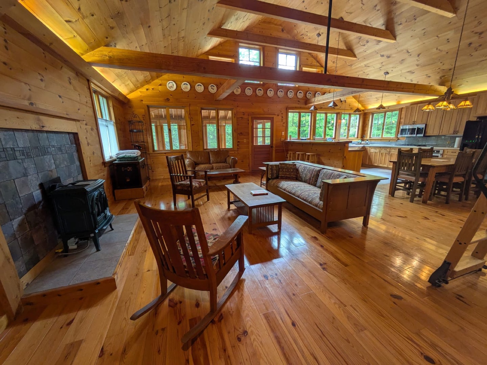 The Nest’s open living room and kitchen, with exposed timber beams and cathedral ceilings